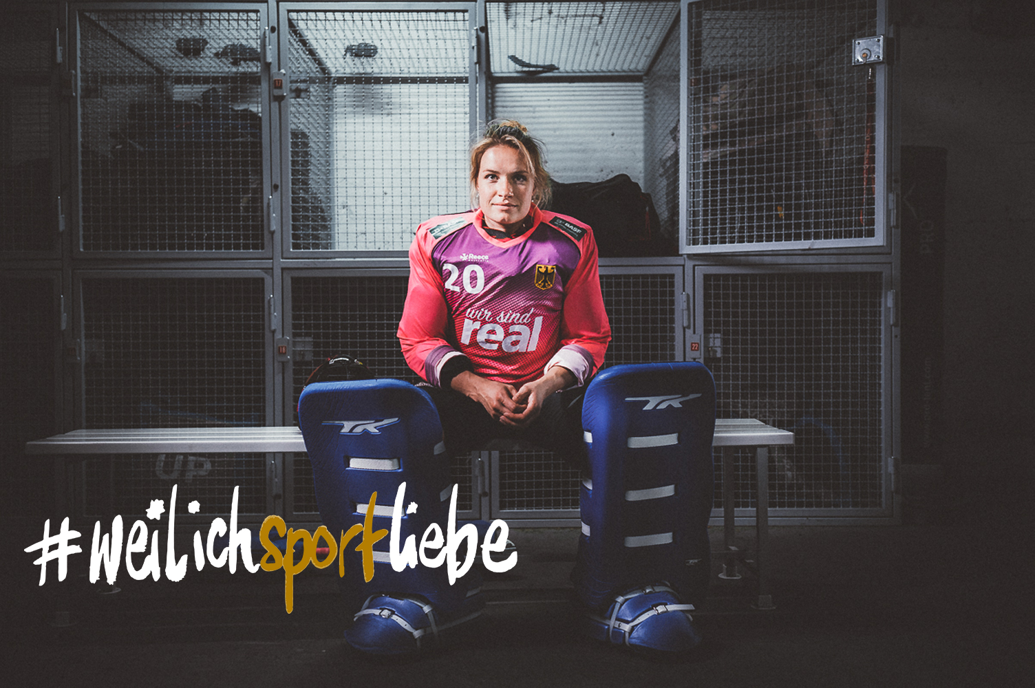 National hockey goalkeeper Julia Sonntag sits in full gear on a bench in the locker room